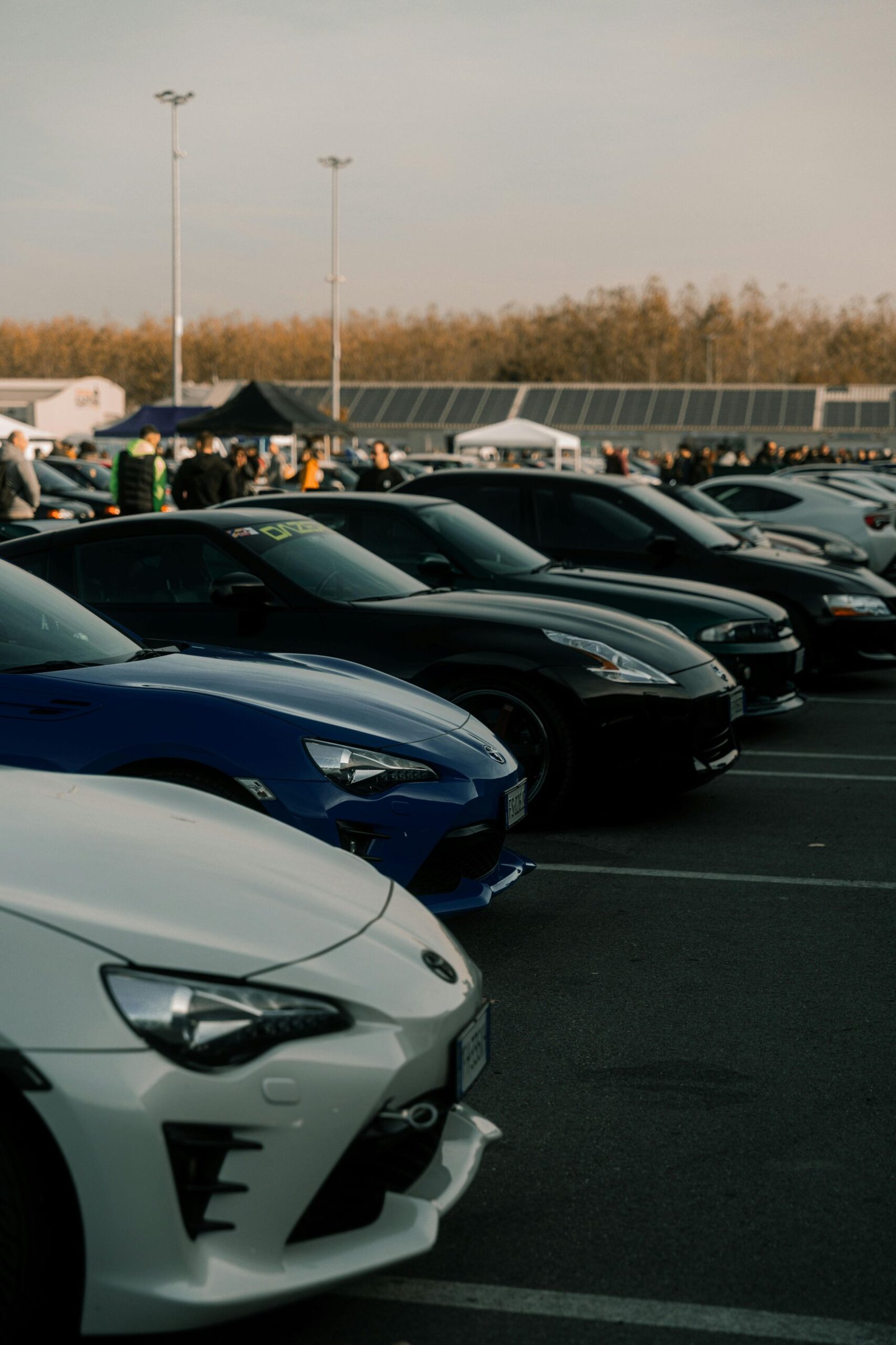 Services Lineup of sports cars at an outdoor event in Cremona, Italy, showcasing automotive diversity.