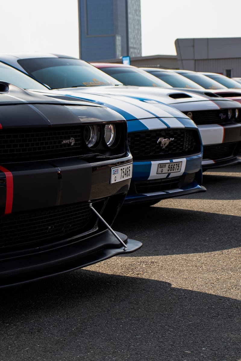 Home Close-up view of a row of parked sports cars, emphasizing their sleek designs.