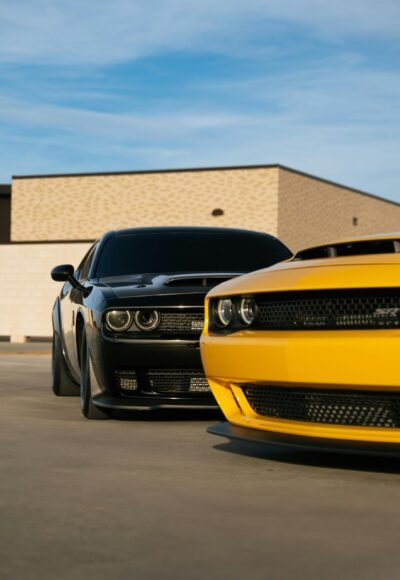 Services A black and yellow muscle car side by side in an outdoor parking area.